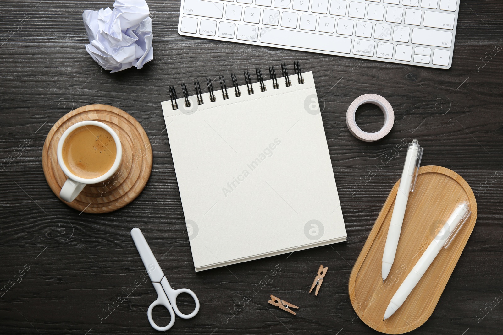 Photo of Flat lay composition with open blank notebook on black wooden table