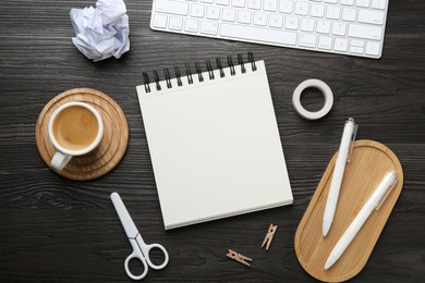 Photo of Flat lay composition with open blank notebook on black wooden table