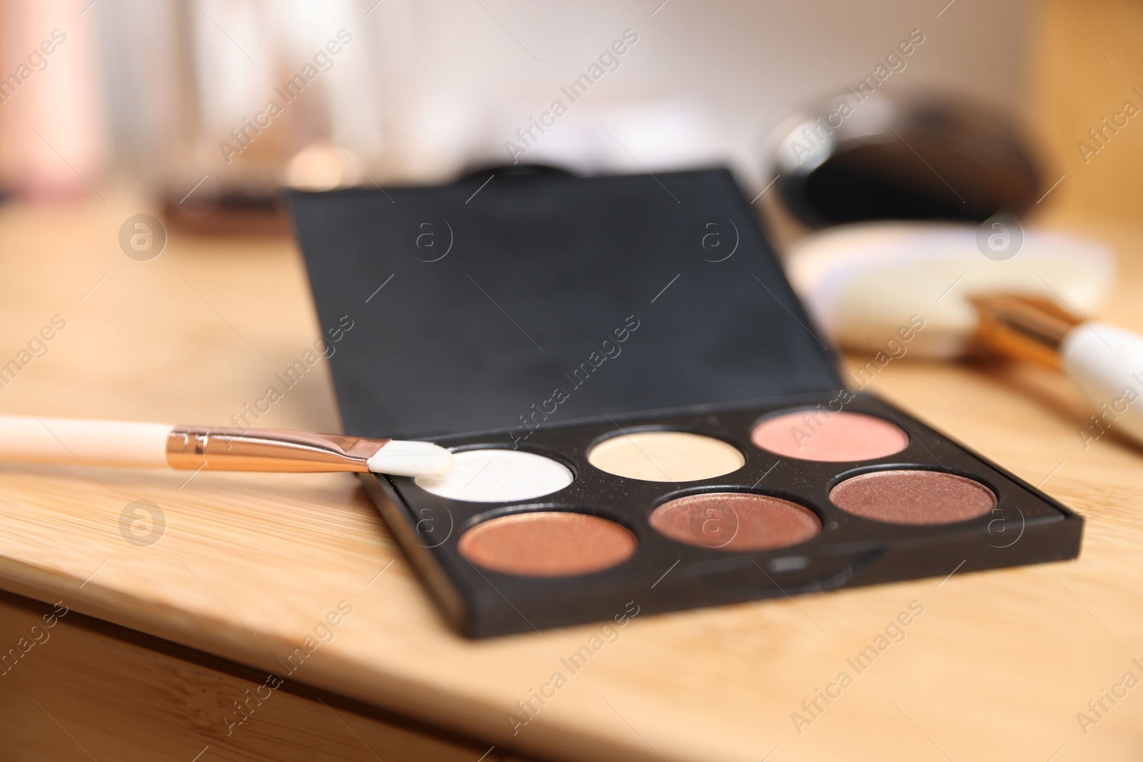 Photo of Different makeup products on wooden vanity indoors, closeup