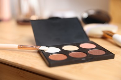 Photo of Different makeup products on wooden vanity indoors, closeup