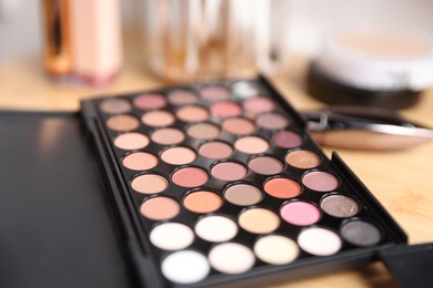 Photo of Different makeup products on wooden vanity indoors, closeup