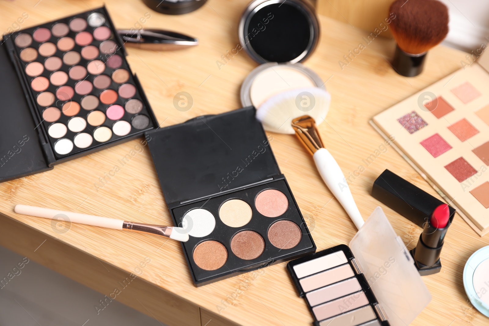 Different makeup products on wooden vanity, above view Photo of Different makeup products on wooden vanity, above view