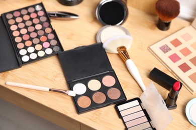 Photo of Different makeup products on wooden vanity, above view