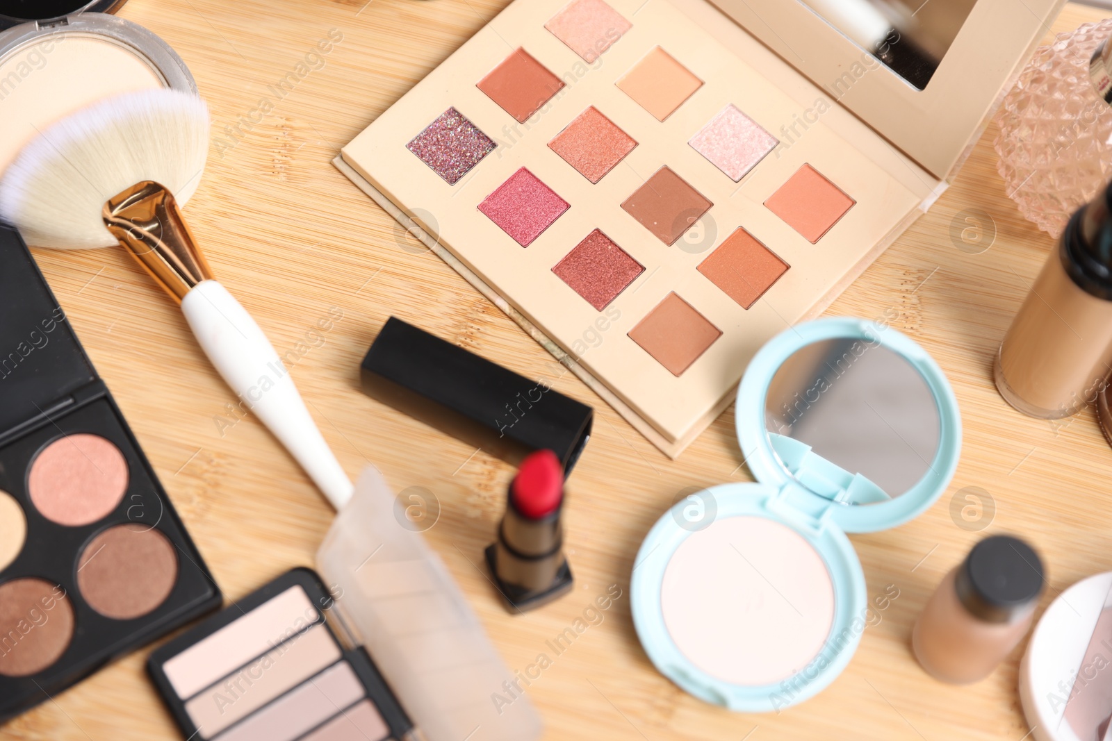 Different makeup products on wooden vanity, above view Photo of Different makeup products on wooden vanity, above view