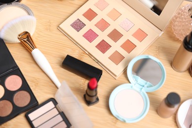 Photo of Different makeup products on wooden vanity, above view