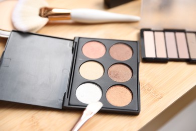 Photo of Different makeup products on wooden vanity, closeup