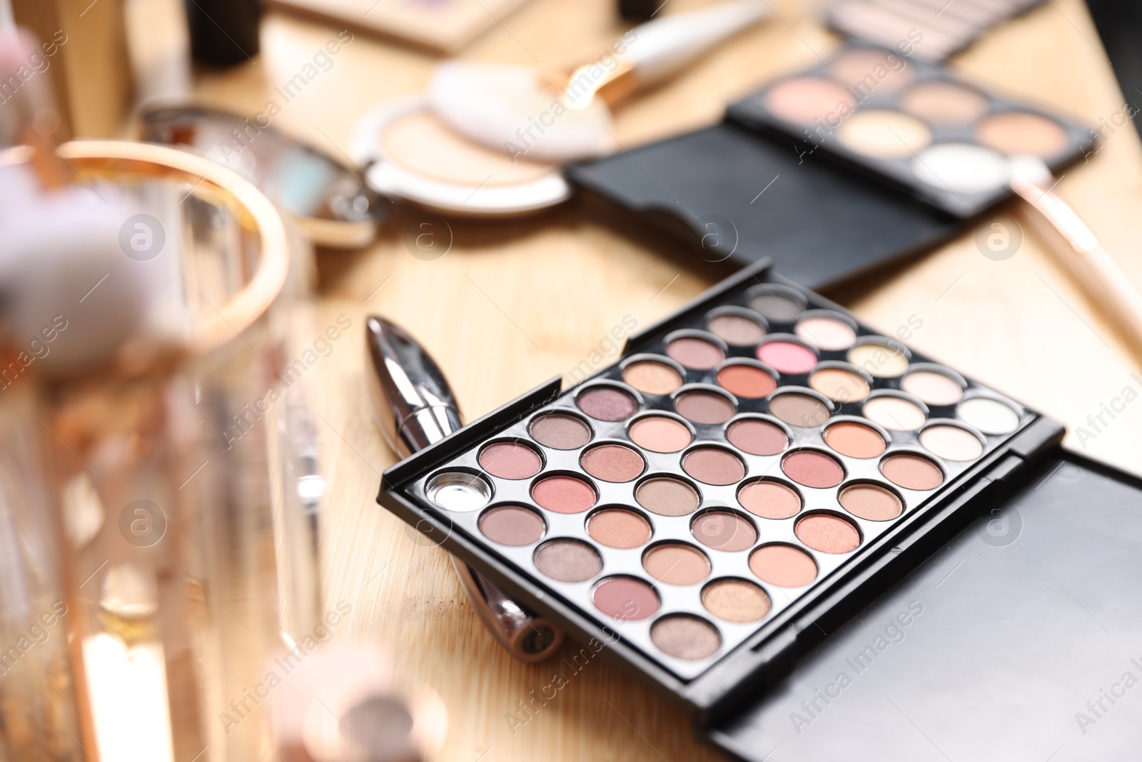 Different makeup products on wooden vanity, closeup Photo of Different makeup products on wooden vanity, closeup