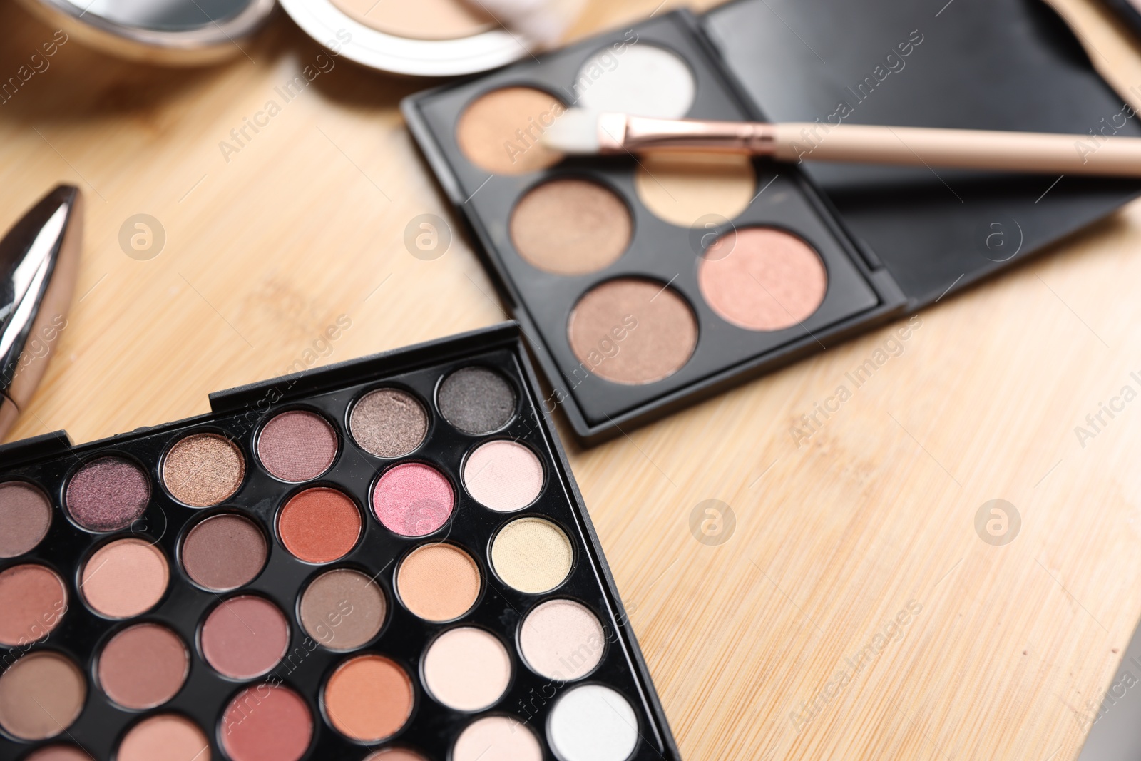 Different makeup products on wooden vanity, closeup Photo of Different makeup products on wooden vanity, closeup