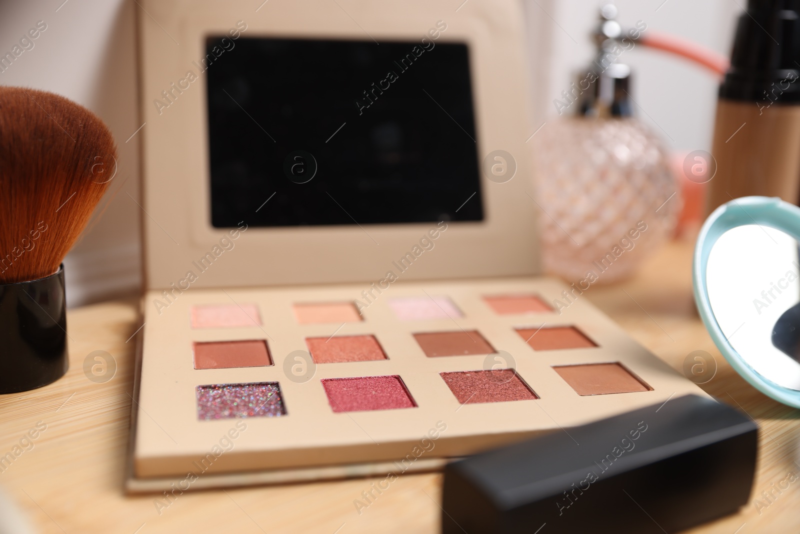 Different makeup products on wooden vanity, closeup Photo of Different makeup products on wooden vanity, closeup