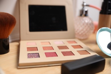 Photo of Different makeup products on wooden vanity, closeup