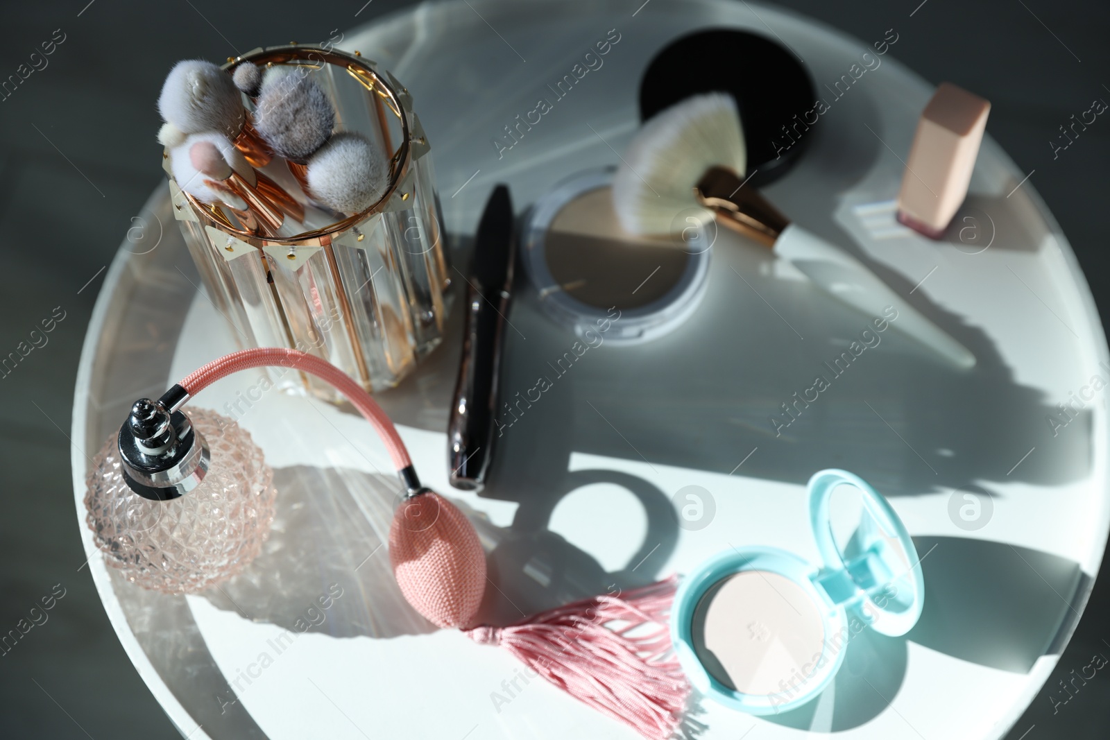 Different makeup products on white table indoors, above view Photo of Different makeup products on white table indoors, above view