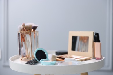 Photo of Different makeup products on white table indoors, closeup