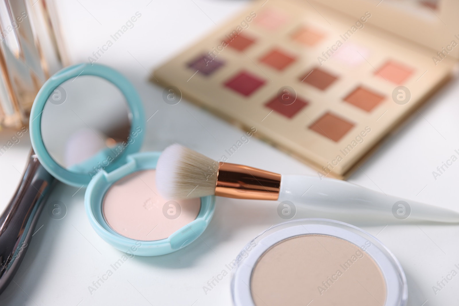 Different makeup products on white table, closeup Photo of Different makeup products on white table, closeup