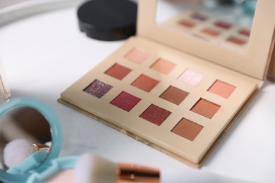 Photo of Different makeup products on white table, closeup