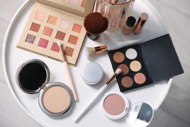 Photo of Different makeup products on white table indoors, flat lay