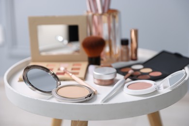 Photo of Different makeup products on white table indoors, closeup
