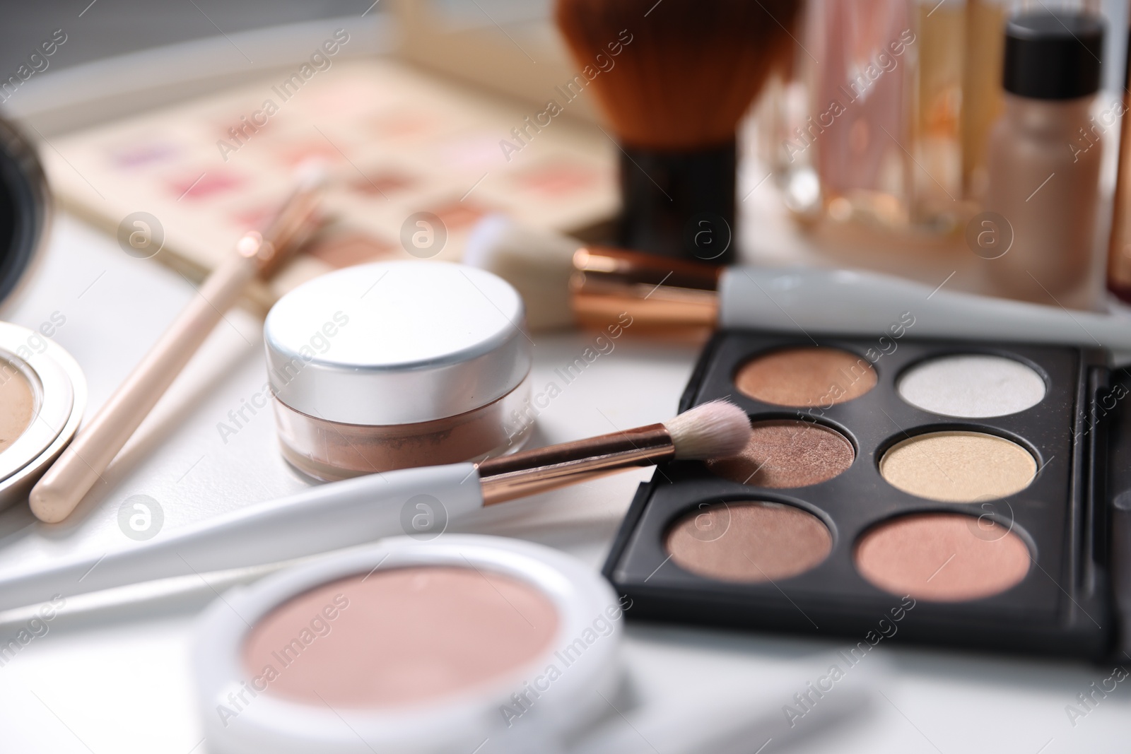 Different makeup products on white table, closeup Photo of Different makeup products on white table, closeup