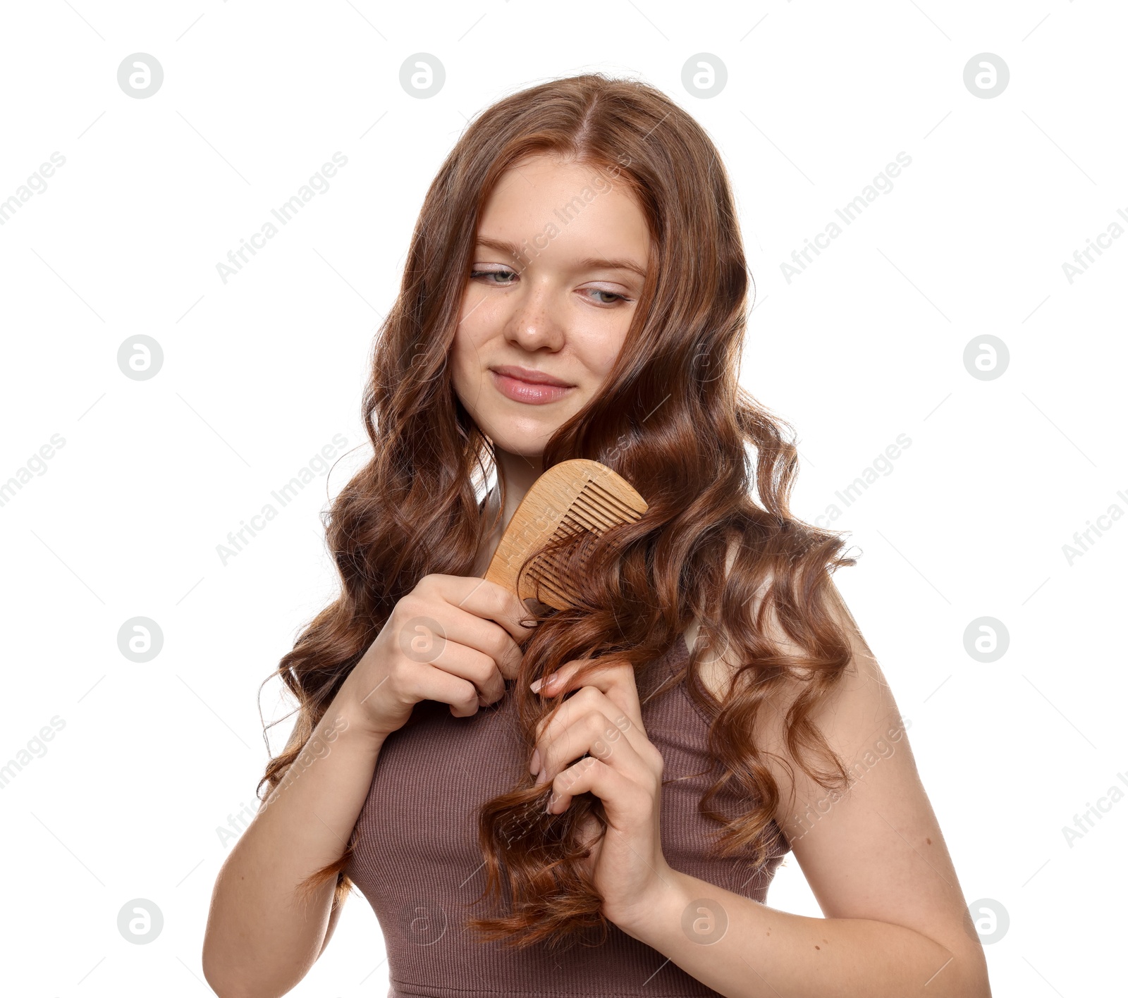 Beautiful teenage girl brushing her shiny hair on white background Photo of Beautiful teenage girl brushing her shiny hair on white background