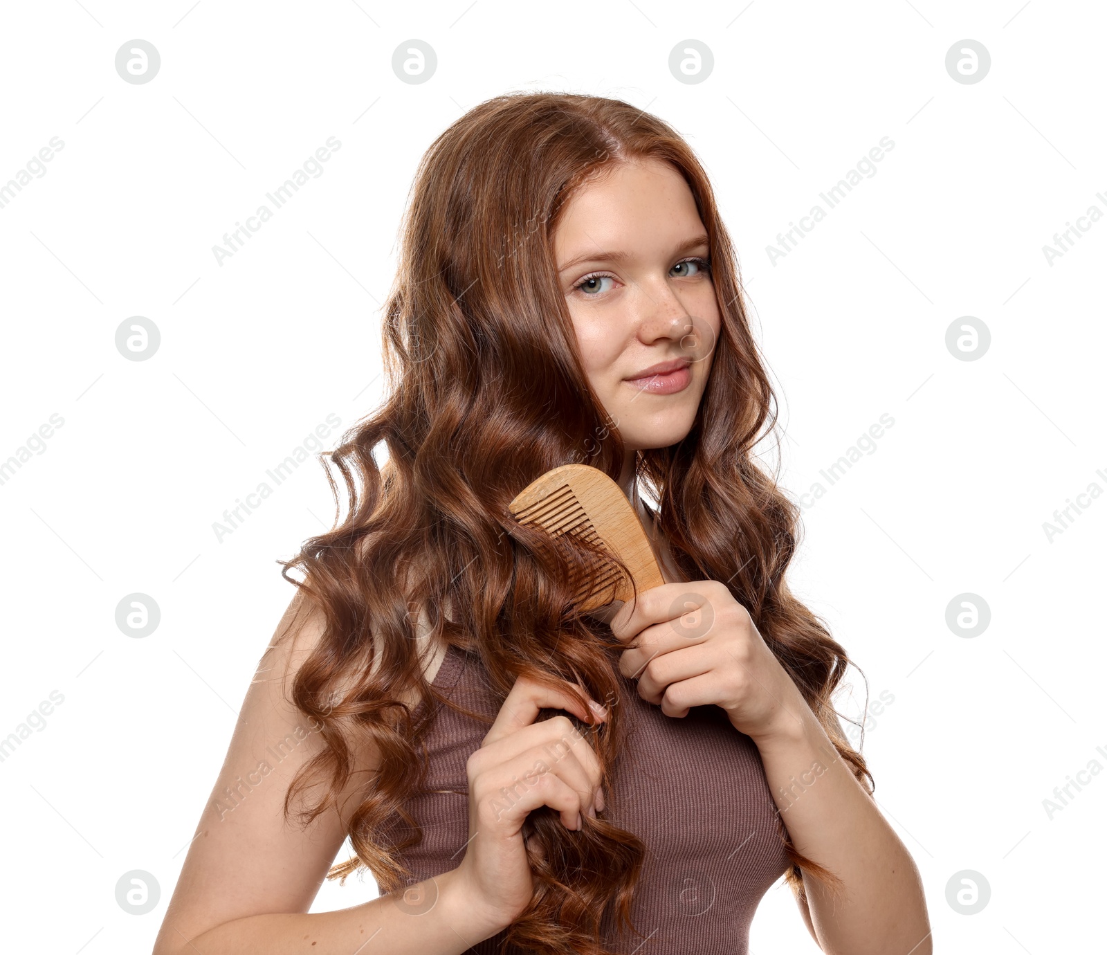 Beautiful teenage girl brushing her shiny hair on white background Photo of Beautiful teenage girl brushing her shiny hair on white background
