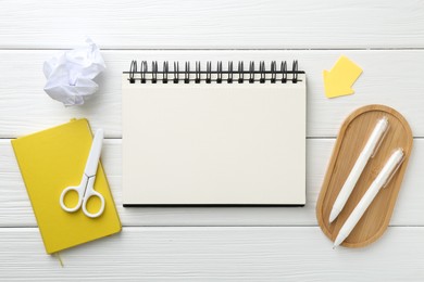 Photo of Flat lay composition with open blank notebook on white wooden table