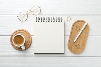 Photo of Flat lay composition with open blank notebook on white wooden table