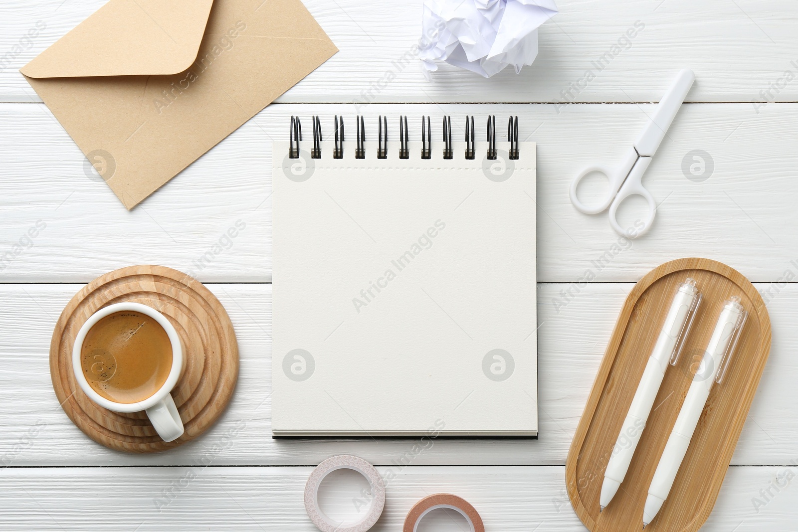 Photo of Flat lay composition with open blank notebook on white wooden table