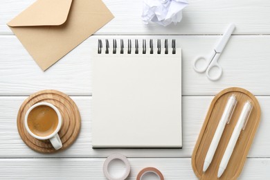 Photo of Flat lay composition with open blank notebook on white wooden table