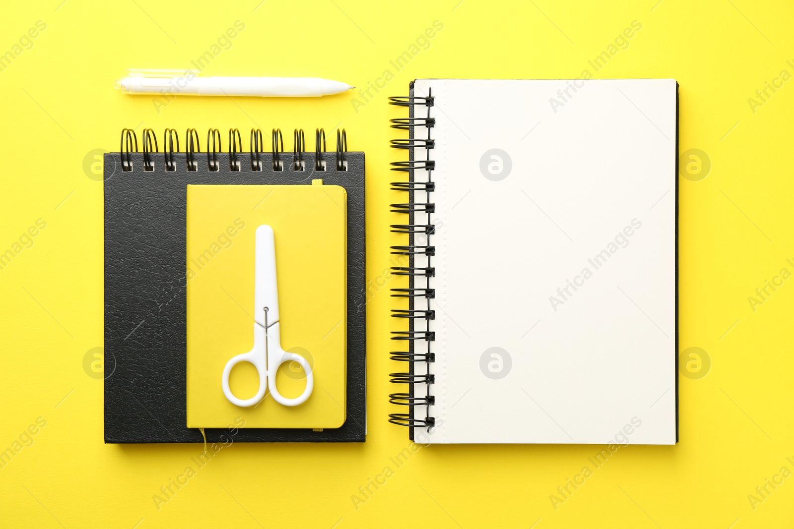 Photo of Flat lay composition with open blank notebook on yellow background