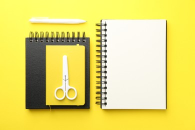 Photo of Flat lay composition with open blank notebook on yellow background
