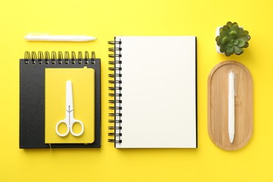 Photo of Flat lay composition with open blank notebook on yellow background