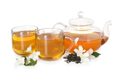 Photo of Aromatic jasmine tea in glass cups, teapot, flowers and leaves isolated on white