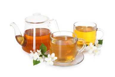 Photo of Aromatic jasmine tea in glass cups, teapot, flowers and green leaves isolated on white