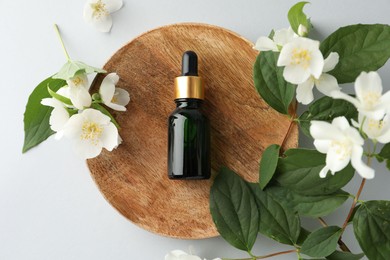 Photo of Cosmetic product and jasmine flowers on white background, flat lay