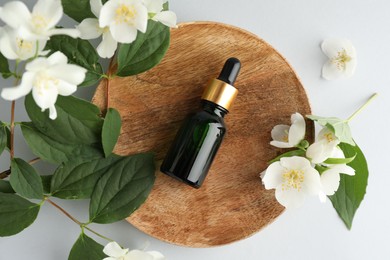 Photo of Cosmetic product and jasmine flowers on white background, flat lay