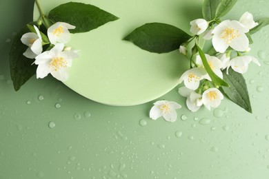 Photo of Beautiful jasmine flowers with leaves on green background, flat lay