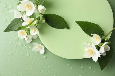 Photo of Beautiful jasmine flowers with leaves on green background, flat lay