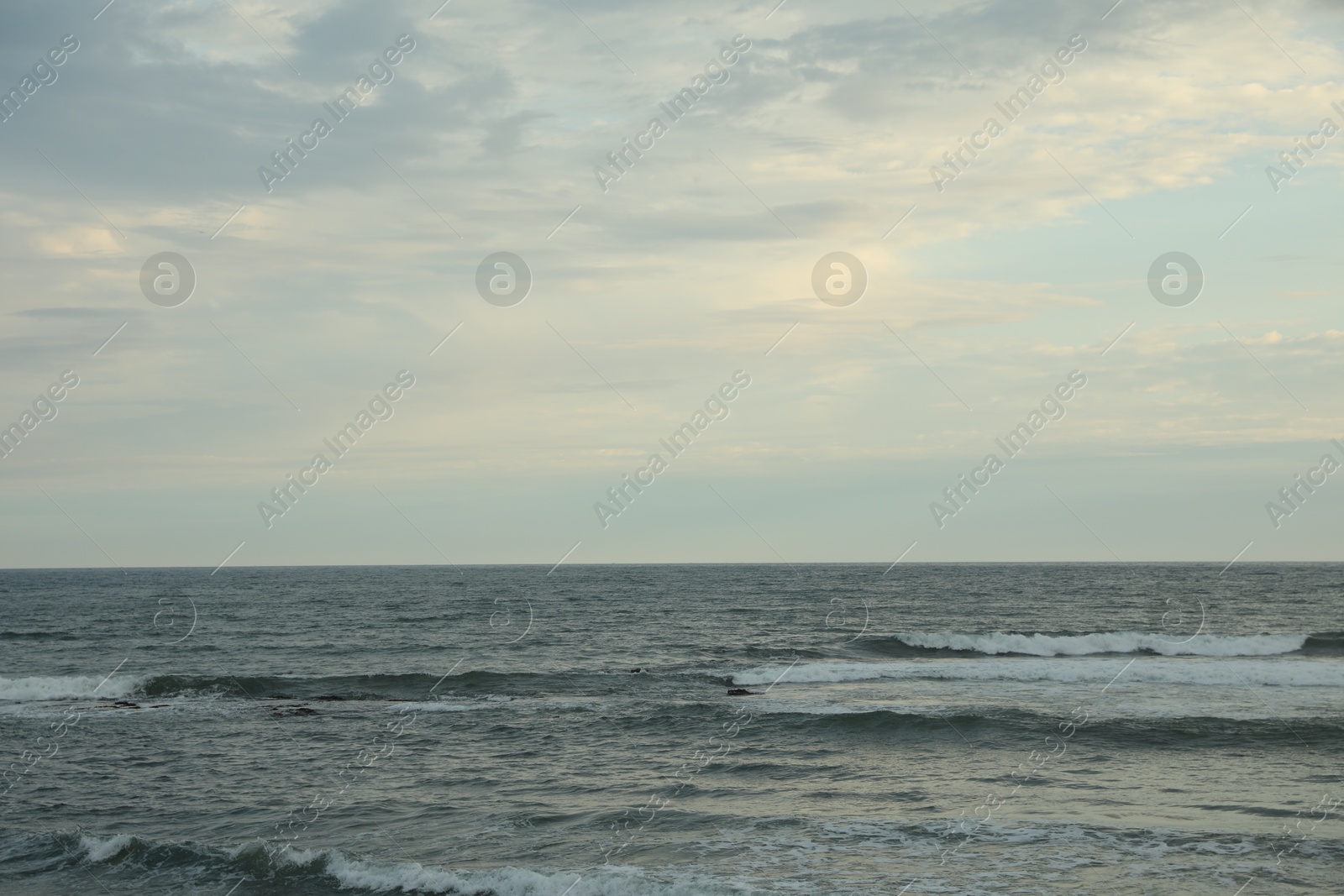 View of beautiful wavy sea under blue sky Photo of View of beautiful wavy sea under blue sky