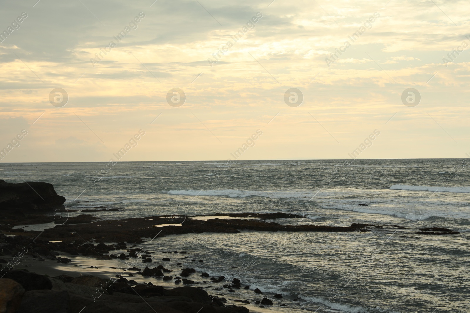 View of beautiful wavy sea and rocky beach Photo of View of beautiful wavy sea and rocky beach