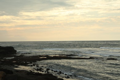 Photo of View of beautiful wavy sea and rocky beach