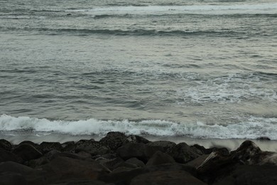 Photo of View of beautiful wavy sea and rocky beach