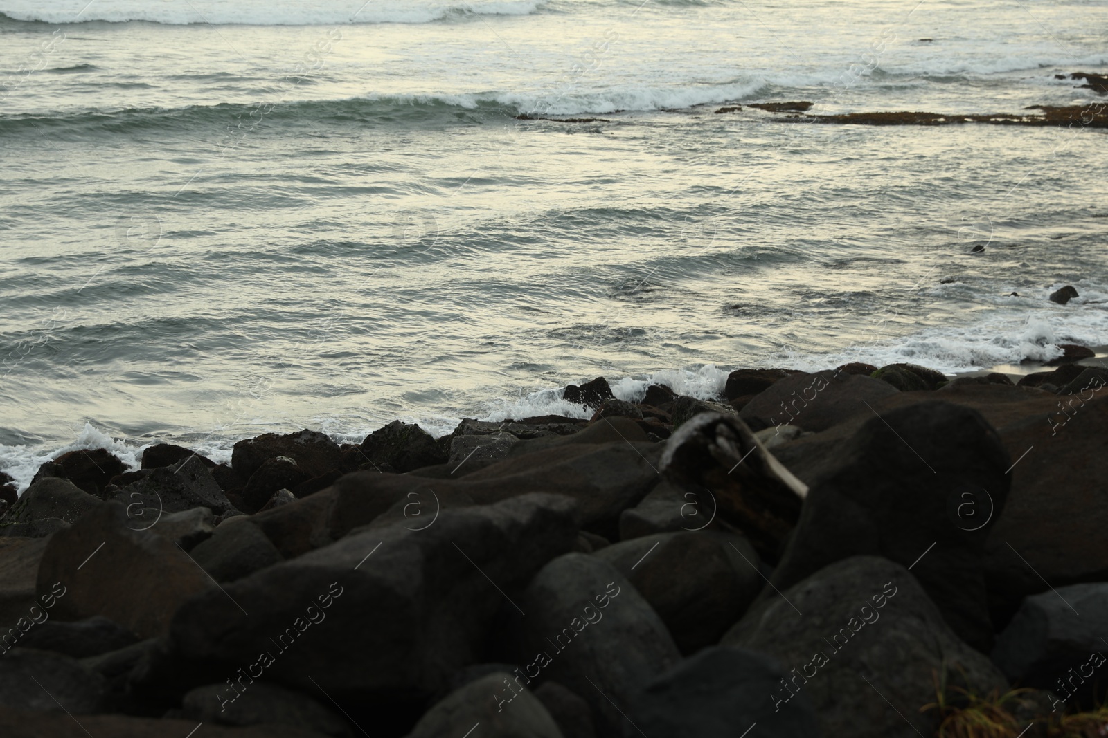 View of beautiful wavy sea and rocky beach Photo of View of beautiful wavy sea and rocky beach