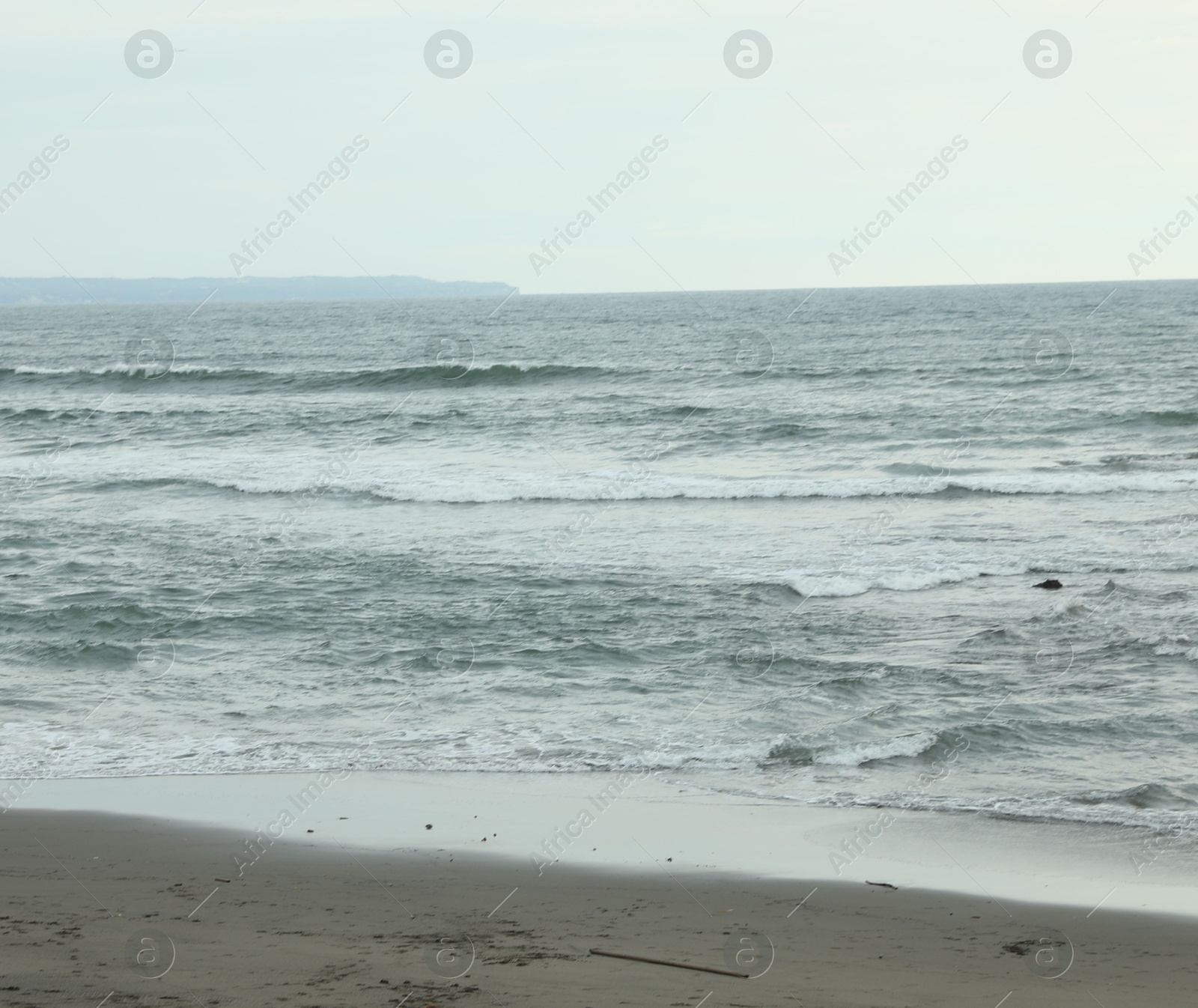 View of beautiful wavy sea and sandy beach Photo of View of beautiful wavy sea and sandy beach