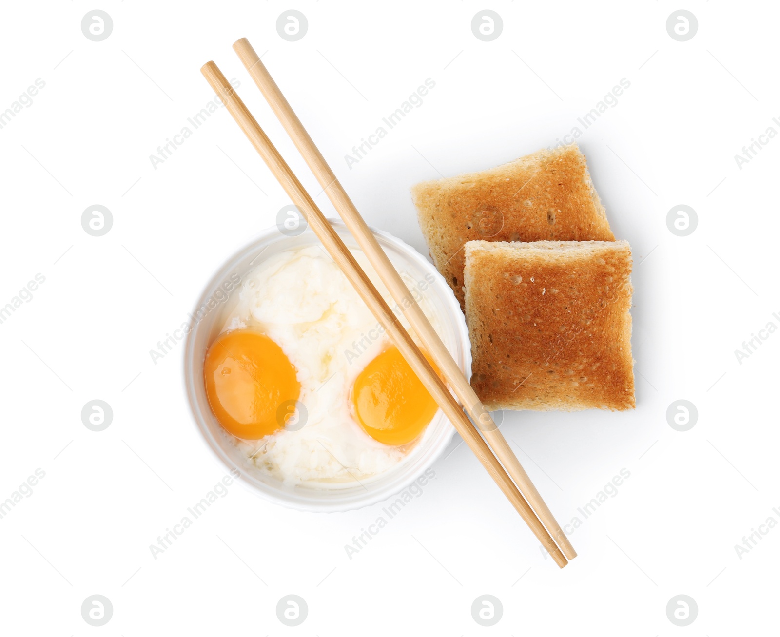 Half-boiled egg in bowl, chopsticks and toasted bread isolated on white, top view Photo of Half-boiled egg in bowl, chopsticks and toasted bread isolated on white, top view