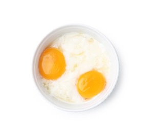 Photo of Half-boiled eggs in bowl isolated on white, top view