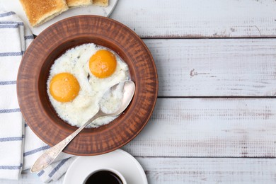 Photo of Half-boiled eggs in plate, coffee and toasted bread on white wooden table, flat lay. Space for text