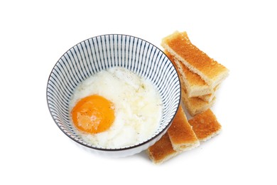 Photo of Half-boiled egg in bowl and toasted bread isolated on white
