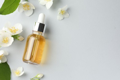Photo of Cosmetic product and jasmine flowers on light background, flat lay. Space for text