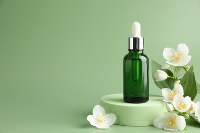Photo of Cosmetic product and jasmine flowers on green background. Space for text