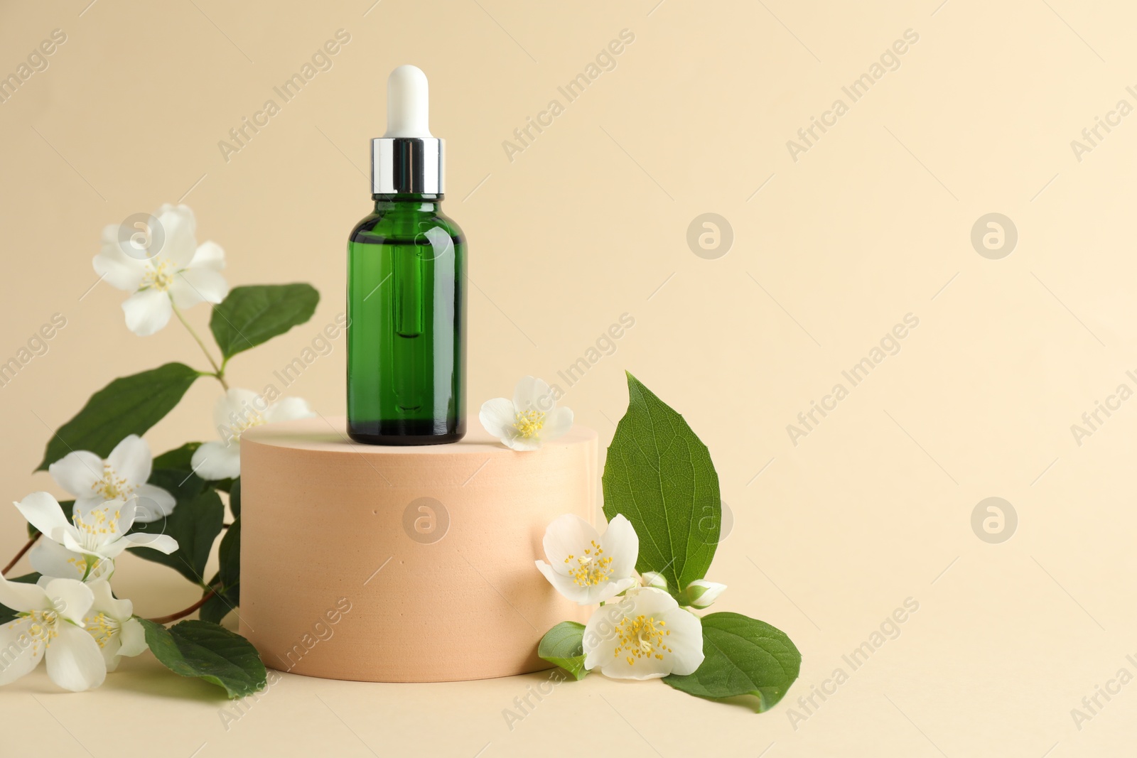 Cosmetic product and jasmine flowers on beige background. Space for text Photo of Cosmetic product and jasmine flowers on beige background. Space for text