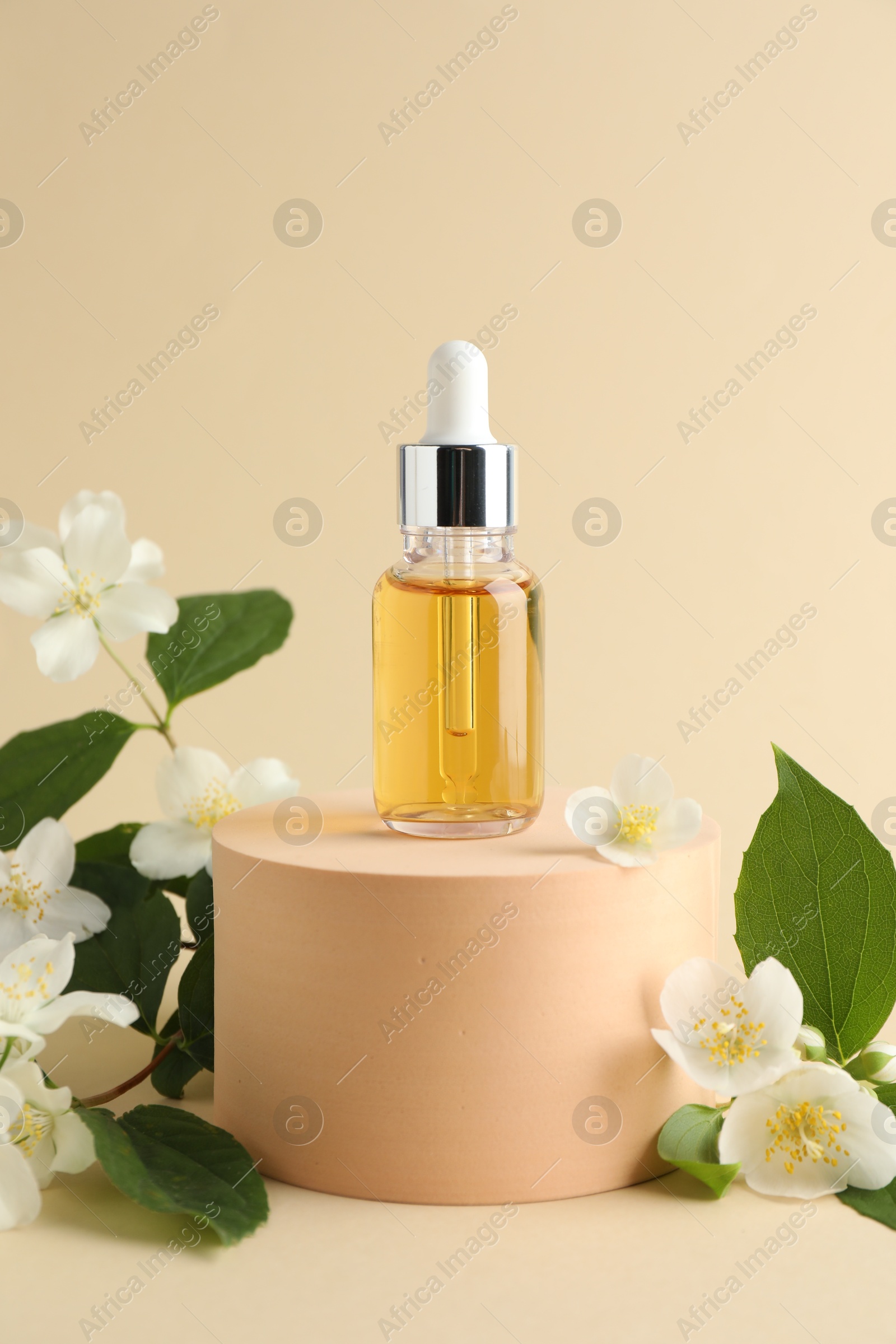 Cosmetic product and jasmine flowers on beige background Photo of Cosmetic product and jasmine flowers on beige background
